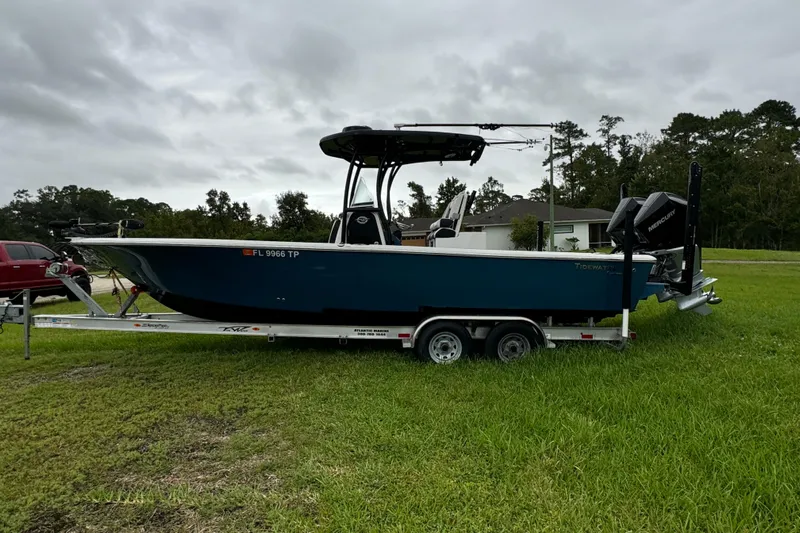 Yacht Photos Pics 2023 Tidewater 2700 Carolina Bay boat on trailer, parked on grass.