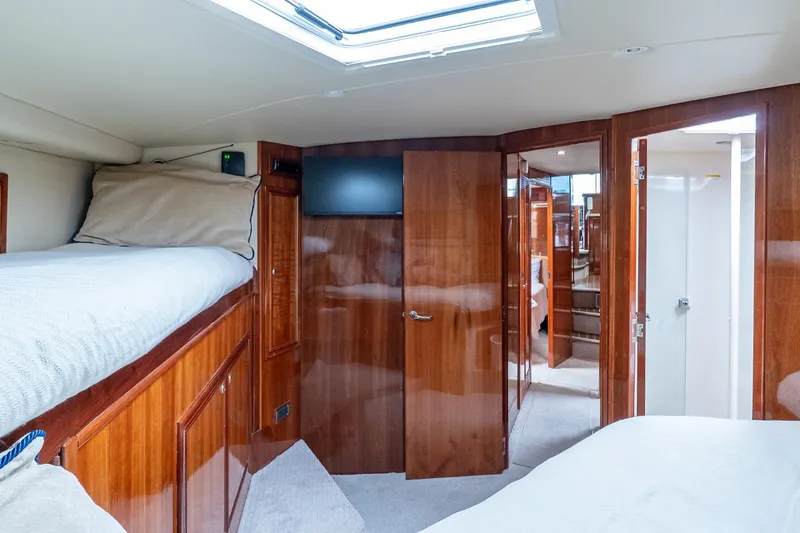 Chillax Yacht Photos Pics Luxurious 2005 Riviera 51 Flybridge yacht interior with cozy cabin and elegant wood finishes.