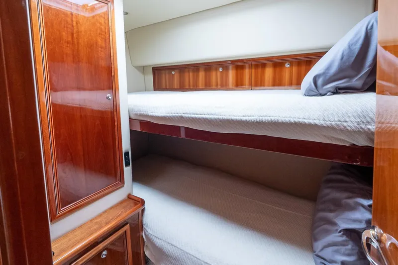 Chillax Yacht Photos Pics 2005 Riviera 51 Flybridge yacht cabin with wooden interior and bunk beds.