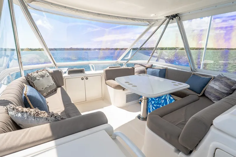 Chillax Yacht Photos Pics Luxurious 2005 Riviera 51 Flybridge interior with plush seating and scenic ocean view.