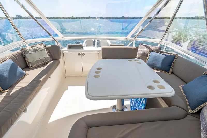 Chillax Yacht Photos Pics Luxurious 2005 Riviera 51 Flybridge interior with plush seating and scenic ocean view.