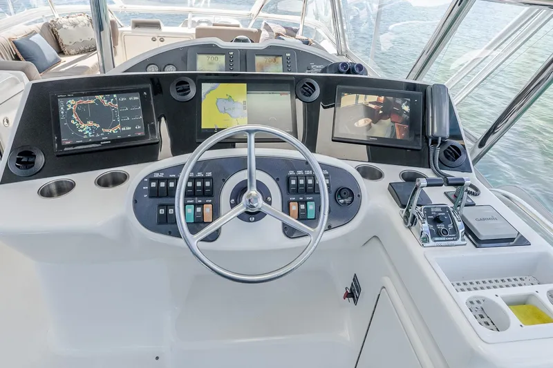 Chillax Yacht Photos Pics 2005 Riviera 51 Flybridge helm with navigation screens and controls.