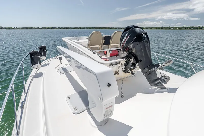 Chillax Yacht Photos Pics 2005 Riviera 51 Flybridge yacht with outboard motor on calm water.