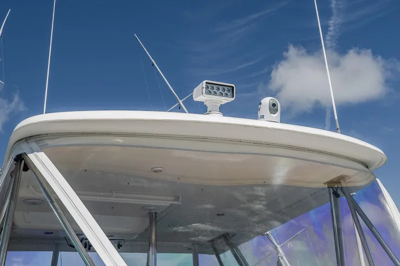 Chillax Yacht Photos Pics 2005 Riviera 51 Flybridge boat with radar equipment against a clear blue sky.