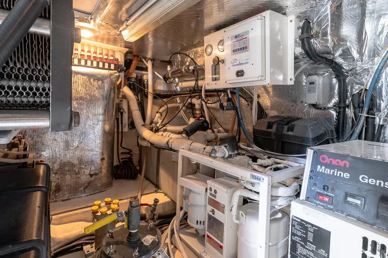 Chillax Yacht Photos Pics Engine room of 2005 Riviera 51 Flybridge yacht with Onan marine generator and control panels.