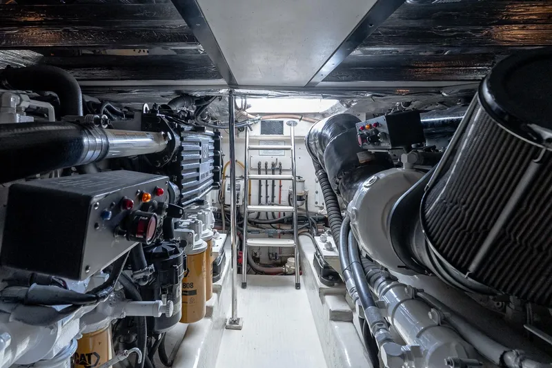 Chillax Yacht Photos Pics Engine room of 2005 Riviera 51 Flybridge yacht, showcasing mechanical components and equipment.