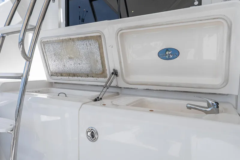 Chillax Yacht Photos Pics 2005 Riviera 51 Flybridge yacht sink and storage area with chrome fixtures.