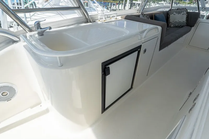 Chillax Yacht Photos Pics 2005 Riviera 51 Flybridge interior with sink, seating, and storage.