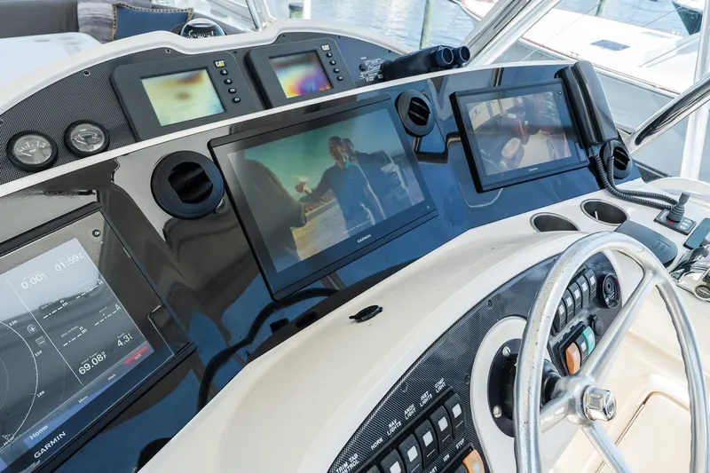 Chillax Yacht Photos Pics 2005 Riviera 51 Flybridge helm with modern navigation displays and controls.