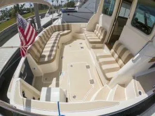 We''ll Sea Yacht Photos Pics 2011 Sabre 40 Sedan yacht deck with striped seating and American flag.
