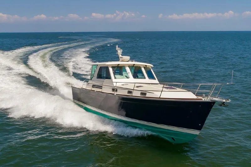 We''ll Sea Yacht Photos Pics 2011 Sabre 40 Sedan cruising on open water, leaving a wake behind.