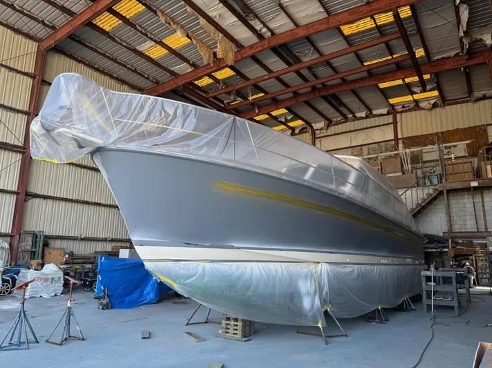 We''ll Sea Yacht Photos Pics 2011 Sabre 40 Sedan yacht under maintenance in a large indoor facility.
