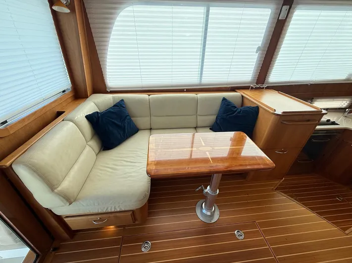 We''ll Sea Yacht Photos Pics Interior of 2011 Sabre 40 Sedan with wood flooring and cushioned seating.