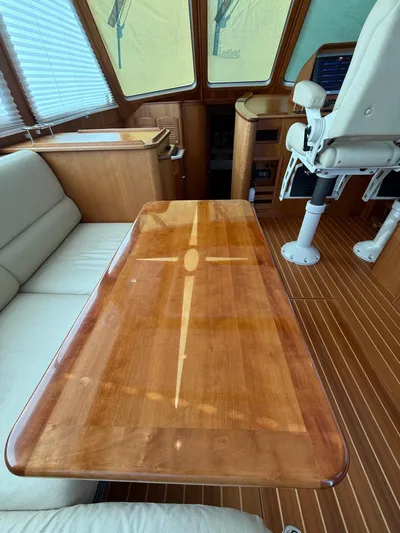 We''ll Sea Yacht Photos Pics Interior of 2011 Sabre 40 Sedan with polished wooden table and seating.