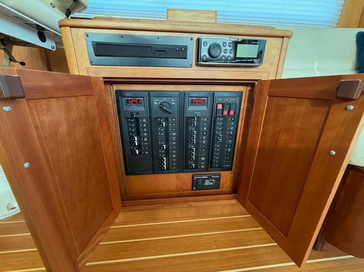We''ll Sea Yacht Photos Pics Electrical panel inside a 2011 Sabre 40 Sedan boat with wooden cabinetry.