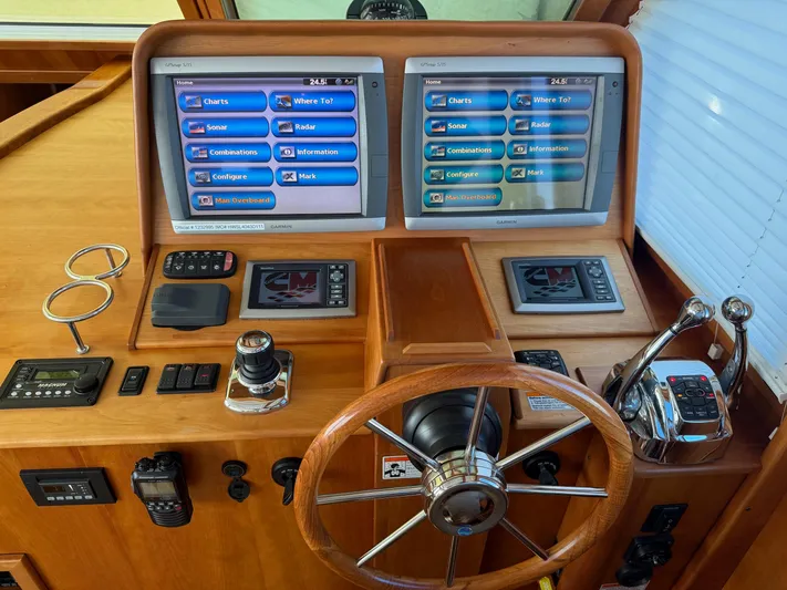 We''ll Sea Yacht Photos Pics Helm of 2011 Sabre 40 Sedan with dual screens and wooden steering wheel.