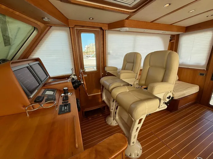We''ll Sea Yacht Photos Pics Interior of 2011 Sabre 40 Sedan yacht with leather seats and wooden dashboard.