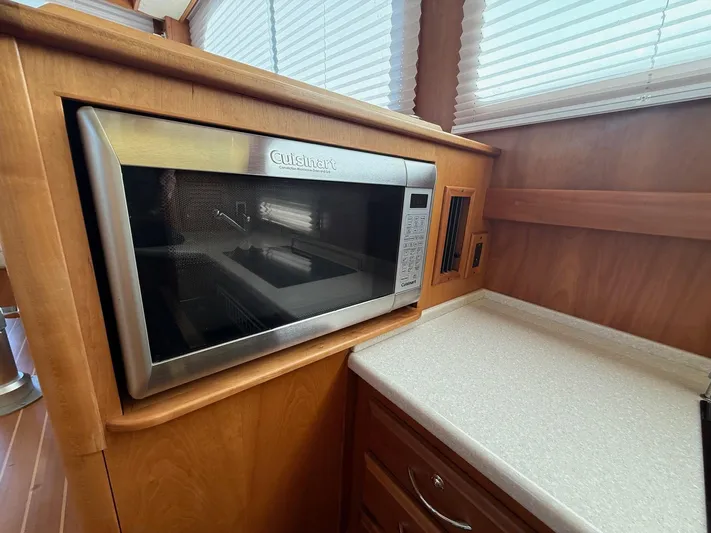 We''ll Sea Yacht Photos Pics Microwave in 2011 Sabre 40 Sedan yacht kitchen with wooden cabinetry.