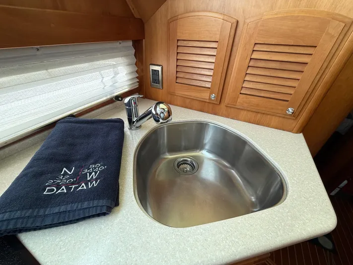 We''ll Sea Yacht Photos Pics Stainless steel sink in 2011 Sabre 40 Sedan yacht with wooden cabinetry.