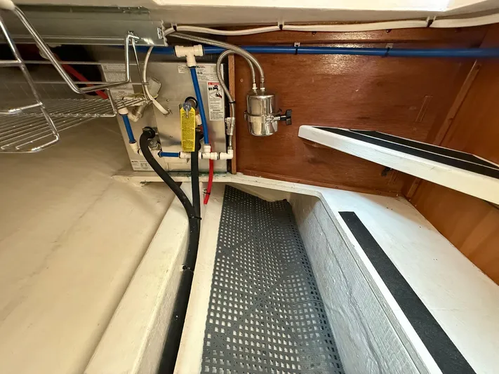 We''ll Sea Yacht Photos Pics Engine room of 2011 Sabre 40 Sedan yacht with visible plumbing and wiring.