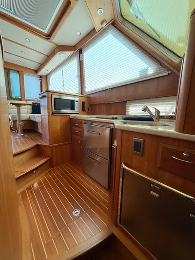 We''ll Sea Yacht Photos Pics Interior of 2011 Sabre 40 Sedan yacht with wood finish and modern kitchen amenities.