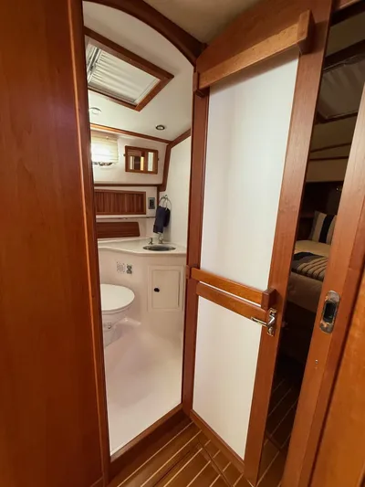 We''ll Sea Yacht Photos Pics Interior of 2011 Sabre 40 Sedan yacht bathroom with wooden accents and modern fixtures.