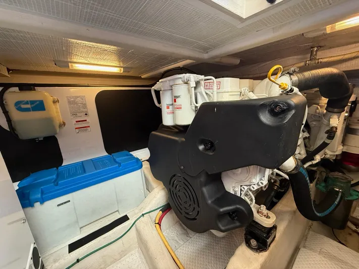 We''ll Sea Yacht Photos Pics Engine room of a 2011 Sabre 40 Sedan yacht, featuring mechanical components and storage.