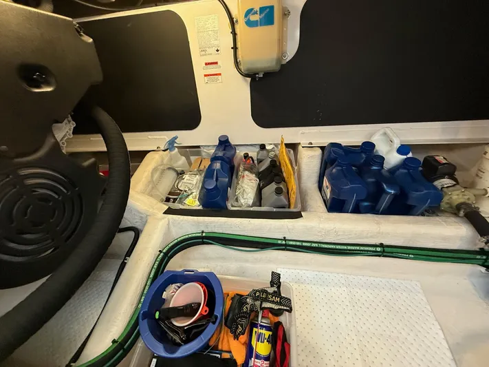 We''ll Sea Yacht Photos Pics Storage area in a 2011 Sabre 40 Sedan with various maintenance supplies and tools.