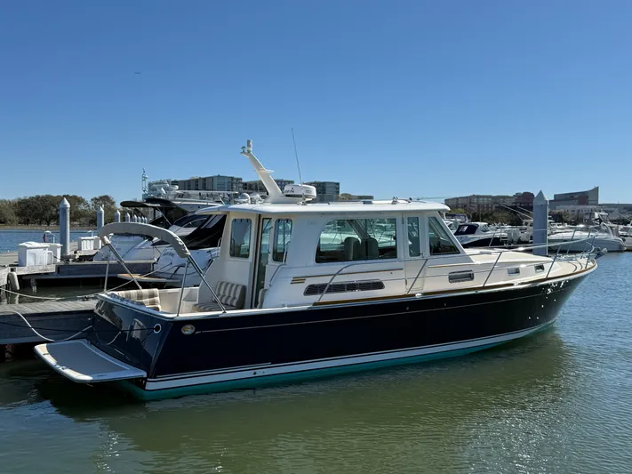 We''ll Sea Yacht Photos Pics 2011 Sabre 40 Sedan yacht docked in a marina under clear blue skies.