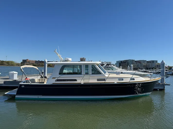 We''ll Sea Yacht Photos Pics 2011 Sabre 40 Sedan yacht docked in a marina under clear blue skies.