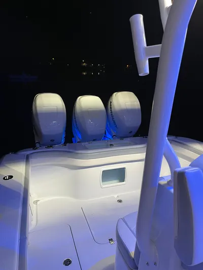  Yacht Photos Pics 2022 Yellowfin 34 boat with triple engines, illuminated at night.