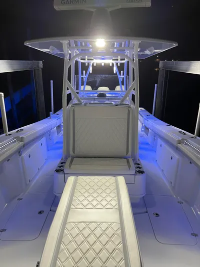  Yacht Photos Pics 2022 Yellowfin 34 boat interior with blue LED lighting and cushioned seating.