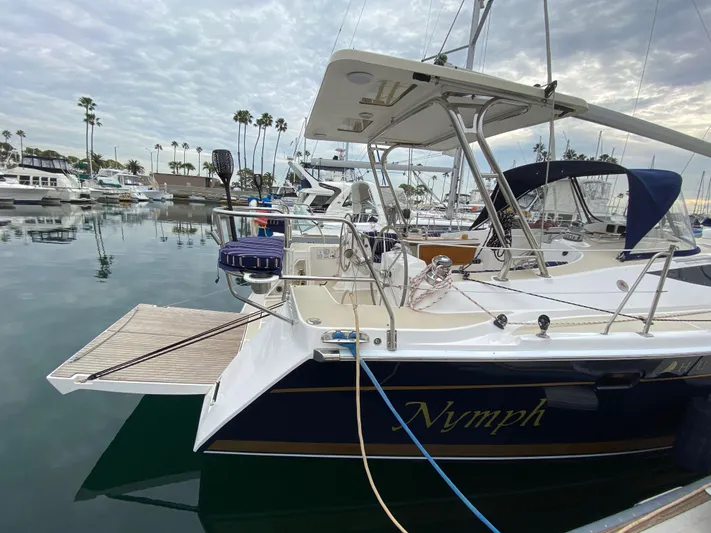Nymph Yacht Photos Pics 2014 Marlow Hunter 40 sailboat docked in a marina, featuring sleek design and spacious deck.