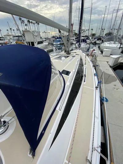 Nymph Yacht Photos Pics 2014 Marlow-Hunter 40 sailboat docked in marina, featuring sleek design and blue canopy.