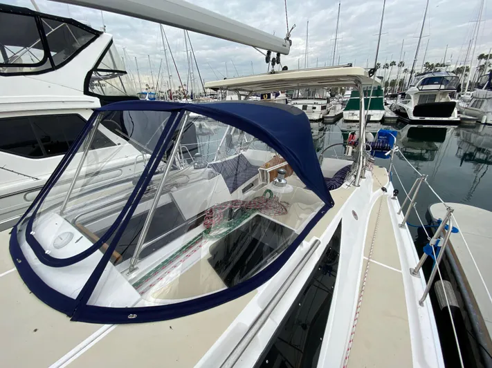 Nymph Yacht Photos Pics 2014 Marlow-Hunter 40 sailboat docked in marina, featuring blue canopy and sleek design.