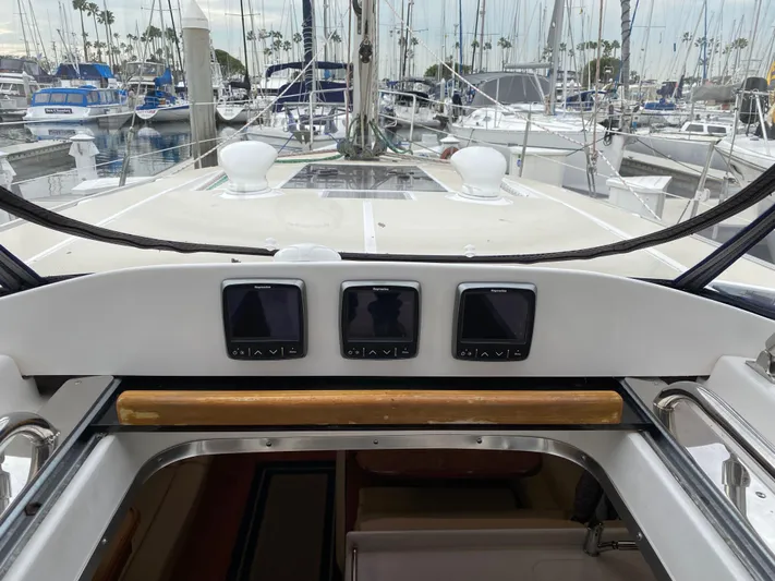 Nymph Yacht Photos Pics 2014 Marlow Hunter 40 sailboat cockpit with navigation instruments, docked in a marina.