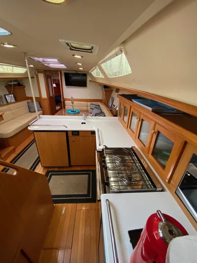 Nymph Yacht Photos Pics Interior of 2014 Marlow Hunter 40 sailboat with modern kitchen and wooden finishes.