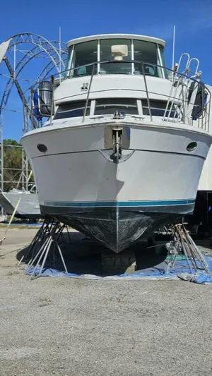 Elusive Yacht Photos Pics 1997 Carver 500 Cockpit Motor Yacht on dry dock, front view, clear blue sky.