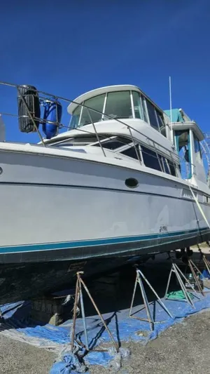 Elusive Yacht Photos Pics 1997 Carver 500 Cockpit Motor Yacht on stands, under clear blue sky.