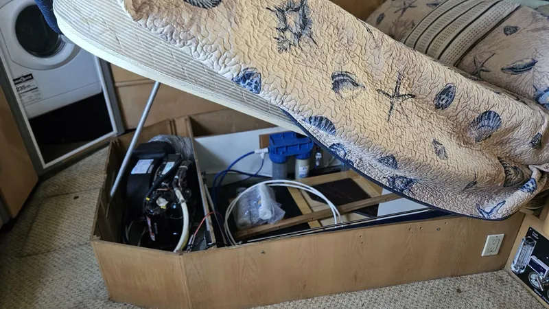 Elusive Yacht Photos Pics 1997 Carver 500 Cockpit Motor Yacht interior with storage under bed.