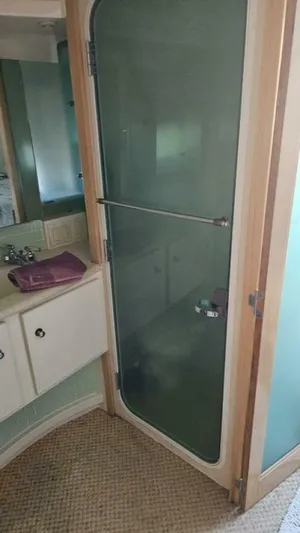 Elusive Yacht Photos Pics Bathroom interior of 1997 Carver 500 Cockpit Motor Yacht with frosted glass shower door.
