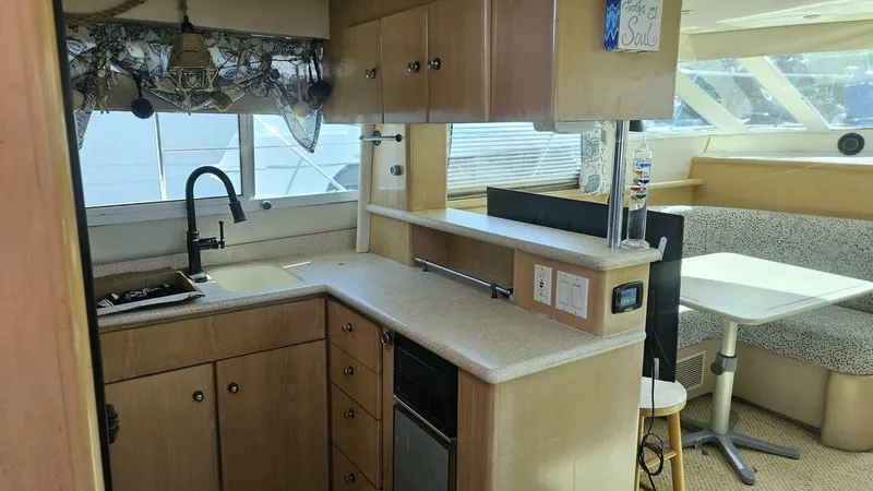 Elusive Yacht Photos Pics Interior of 1997 Carver 500 Cockpit Motor Yacht with kitchen and dining area.