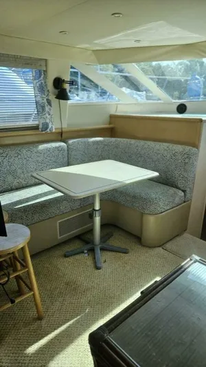 Elusive Yacht Photos Pics Interior of 1997 Carver 500 Cockpit Motor Yacht with cozy seating and table.