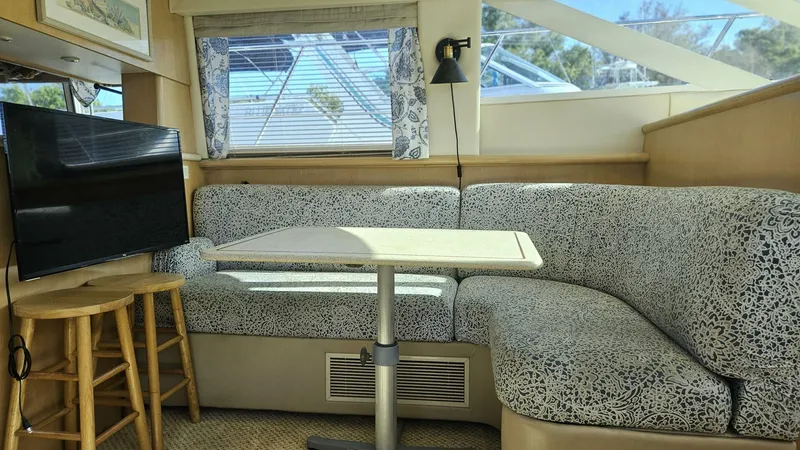 Elusive Yacht Photos Pics Interior of 1997 Carver 500 Cockpit Motor Yacht with cozy seating and table.