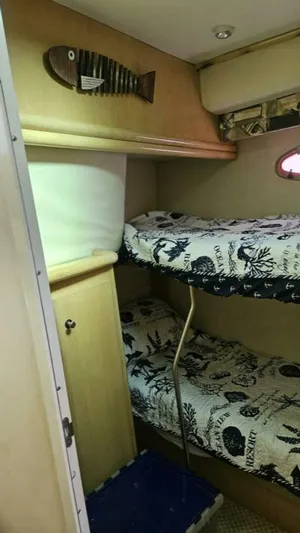 Elusive Yacht Photos Pics 1997 Carver 500 Cockpit Motor Yacht cabin with bunk beds and nautical decor.