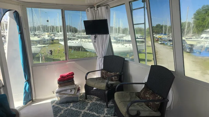 Elusive Yacht Photos Pics Interior of 1997 Carver 500 Cockpit Motor Yacht with chairs and marina view.