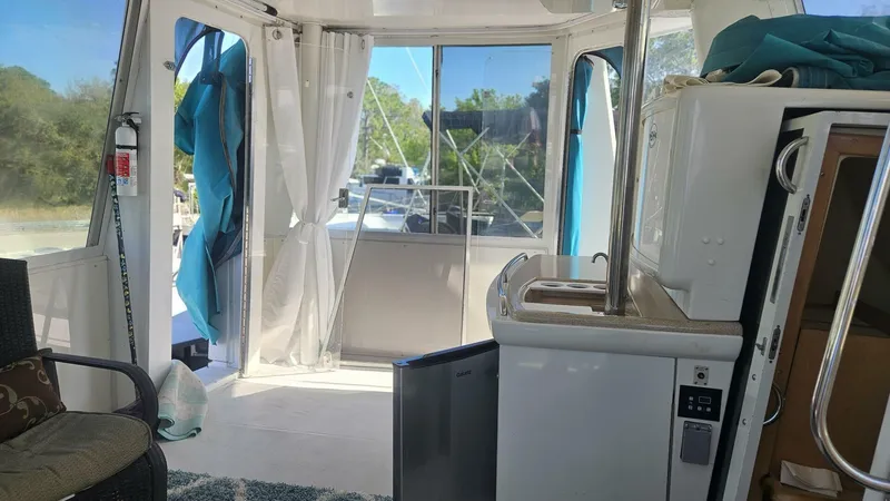 Elusive Yacht Photos Pics Interior of a 1997 Carver 500 Cockpit Motor Yacht with kitchenette and seating area.