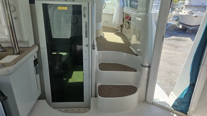 Elusive Yacht Photos Pics Interior view of 1997 Carver 500 Cockpit Motor Yacht with steps and glass door.