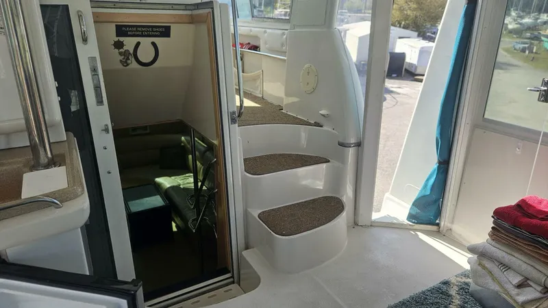 Elusive Yacht Photos Pics Interior view of 1997 Carver 500 Cockpit Motor Yacht with stairs and cozy seating area.