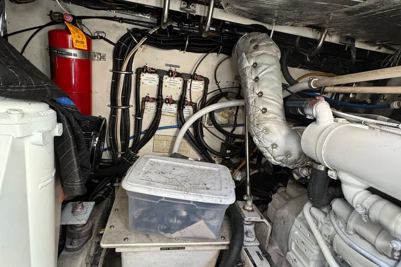 Dark And Stormy Yacht Photos Pics Engine room of a 2000 Tiara Yachts 3500 Express, featuring mechanical components and fire extinguisher.